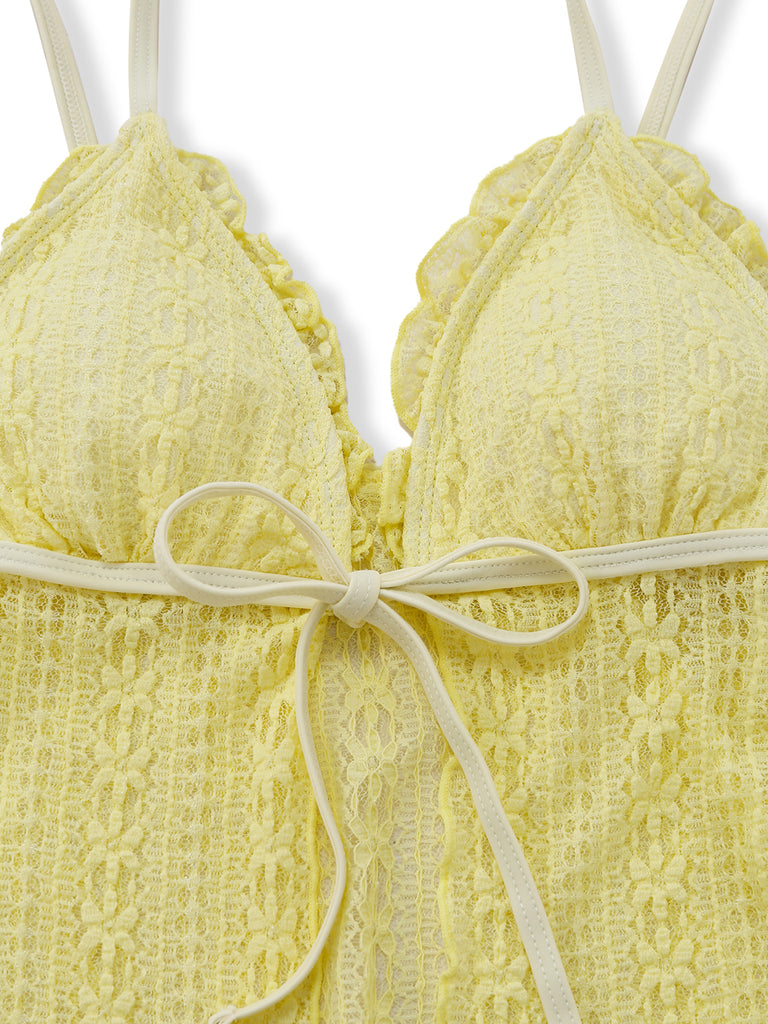 Yellow lace bra with a bow on a white background