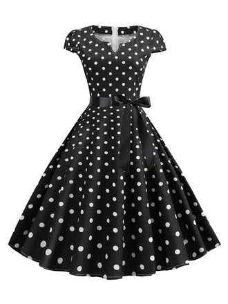 She slips into this 1950s Cap Sleeve Polka Dot Belted Dress and suddenly it's a 1950s daydream