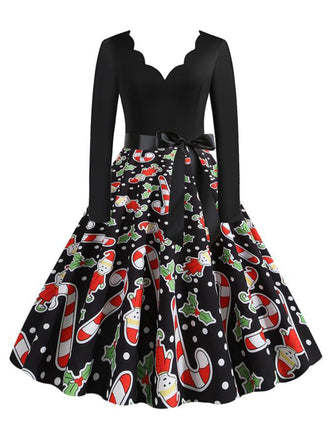 She slips into this 1950s Christmas Candy Canes Swing Dress and suddenly it's a 1950s daydream