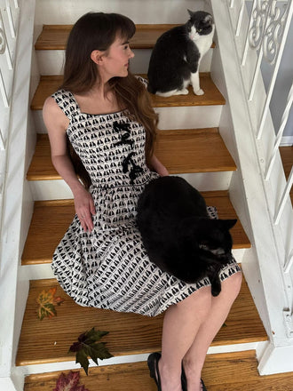 She slips into this 1950s Halloween Cat Print Velvet Bow Dress and suddenly it's a 1950s daydream