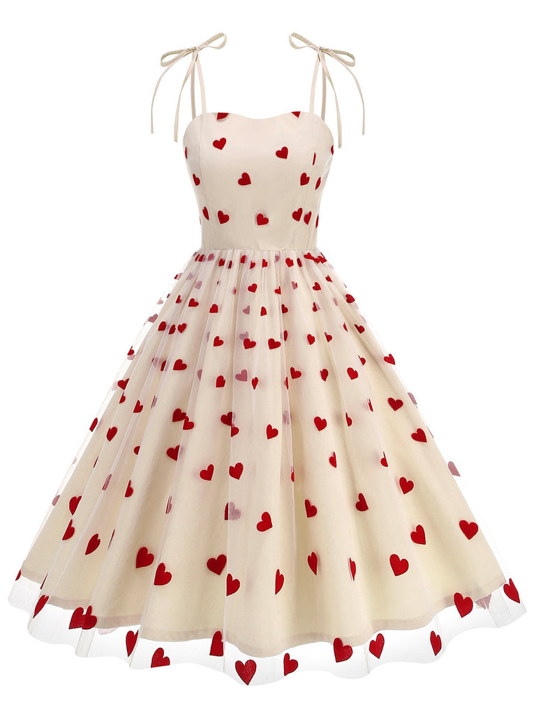 She slips into this 1950s Heart Mesh Patchwork Suspender Dress and suddenly it's a 1950s daydream