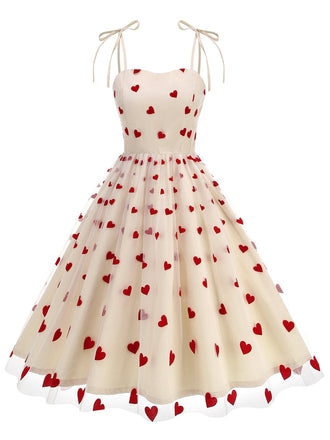 She slips into this 1950s Heart Mesh Patchwork Suspender Dress and suddenly it's a 1950s daydream