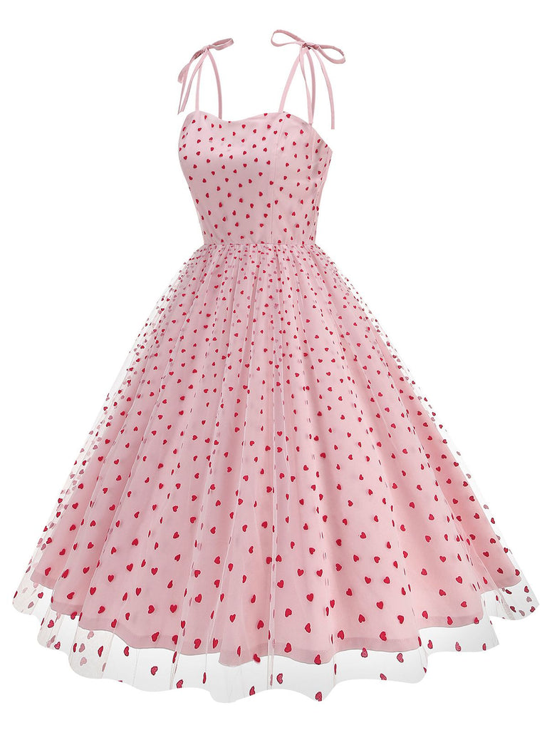 She slips into this 1950s Heart Mesh Patchwork Suspender Dress and suddenly it's a 1950s daydream