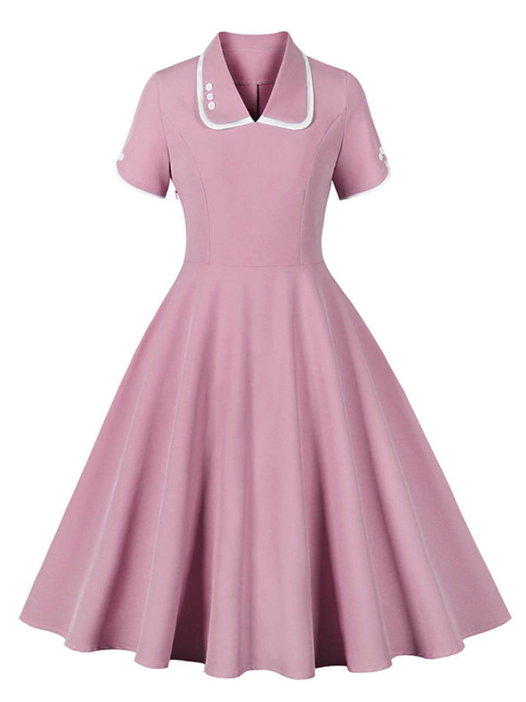 She slips into this 1950s Lapel Buttoned Short Sleeve Solid Dress and suddenly it's a 1950s daydream