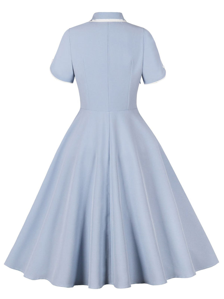 She slips into this 1950s Lapel Buttoned Short Sleeve Solid Dress and suddenly it's a 1950s daydream