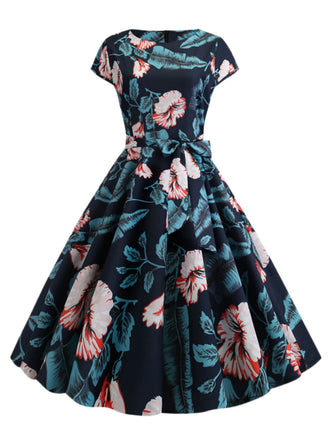 She slips into this 1950s Retro Floral Swing Dress and suddenly it's a 1950s daydream