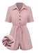She pairs this 1950s Shirt Neck Lace-Up Solid Romper with confidence and 1950s charm