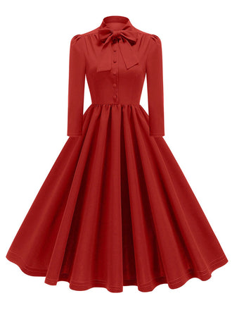 She slips into this 1950s Solid Bow Collar Buttoned Swing Dress and suddenly it's a 1950s daydream