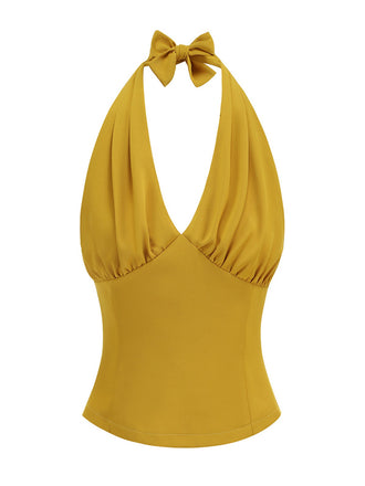 She pairs this 1950s Solid Sleeveless Halter Ruched Top with confidence and 1950s charm