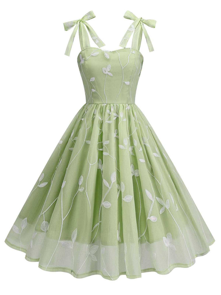 This 1950s Spaghetti Strap Bow Leaves Mesh Dress wraps her in 1950s elegance, one twirl at a time