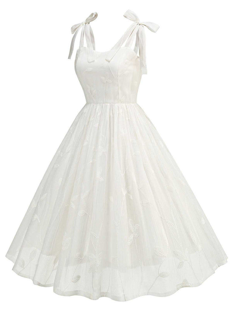 This 1950s Spaghetti Strap Bow Leaves Mesh Dress wraps her in 1950s elegance, one twirl at a time