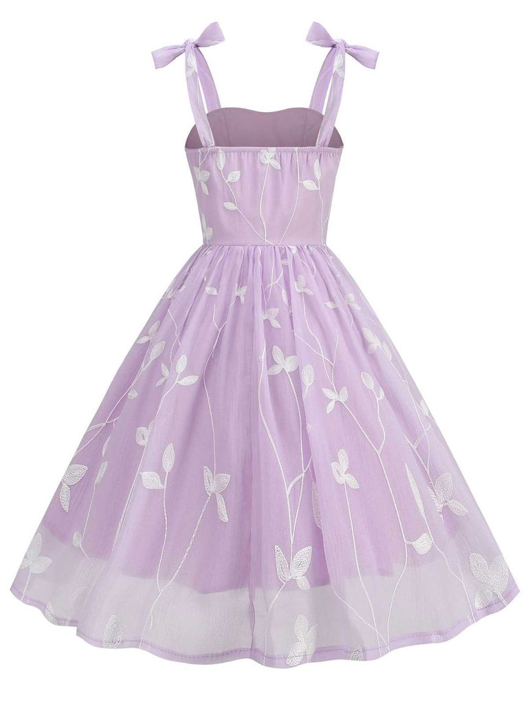 This 1950s Spaghetti Strap Bow Leaves Mesh Dress wraps her in 1950s elegance, one twirl at a time