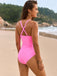 She's wearing 1950s Spaghetti Strap Cross-Back One-Piece Swimsuit and the whole beach remembers the 1950s