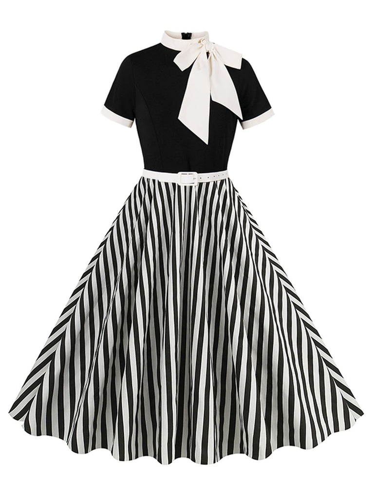 She slips into this 1950s Tie Neck Black & White Stripes Belted Dress and suddenly it's a 1950s daydream