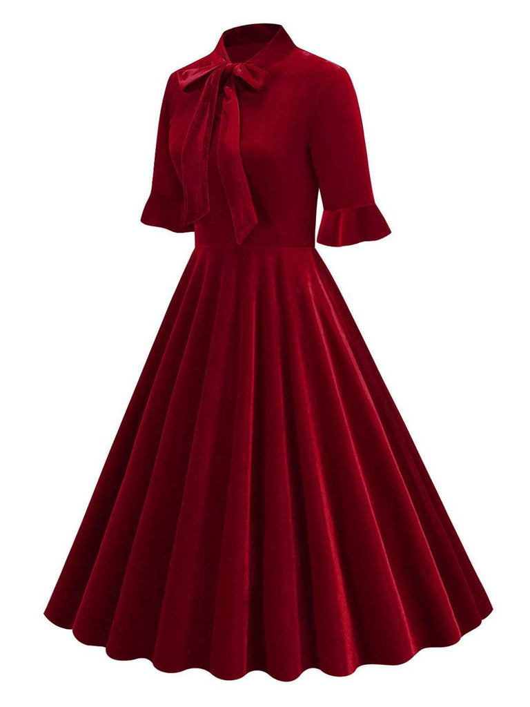 She slips into this 1950s Tie Neck Velvet Flared S