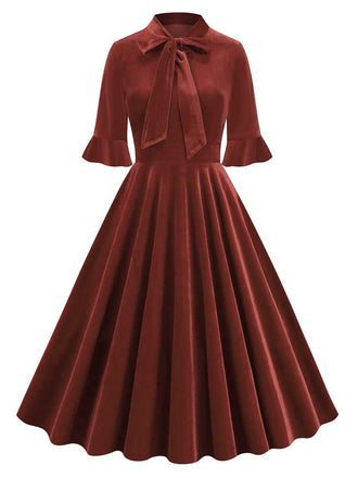 She slips into this 1950s Tie Neck Velvet Flared S