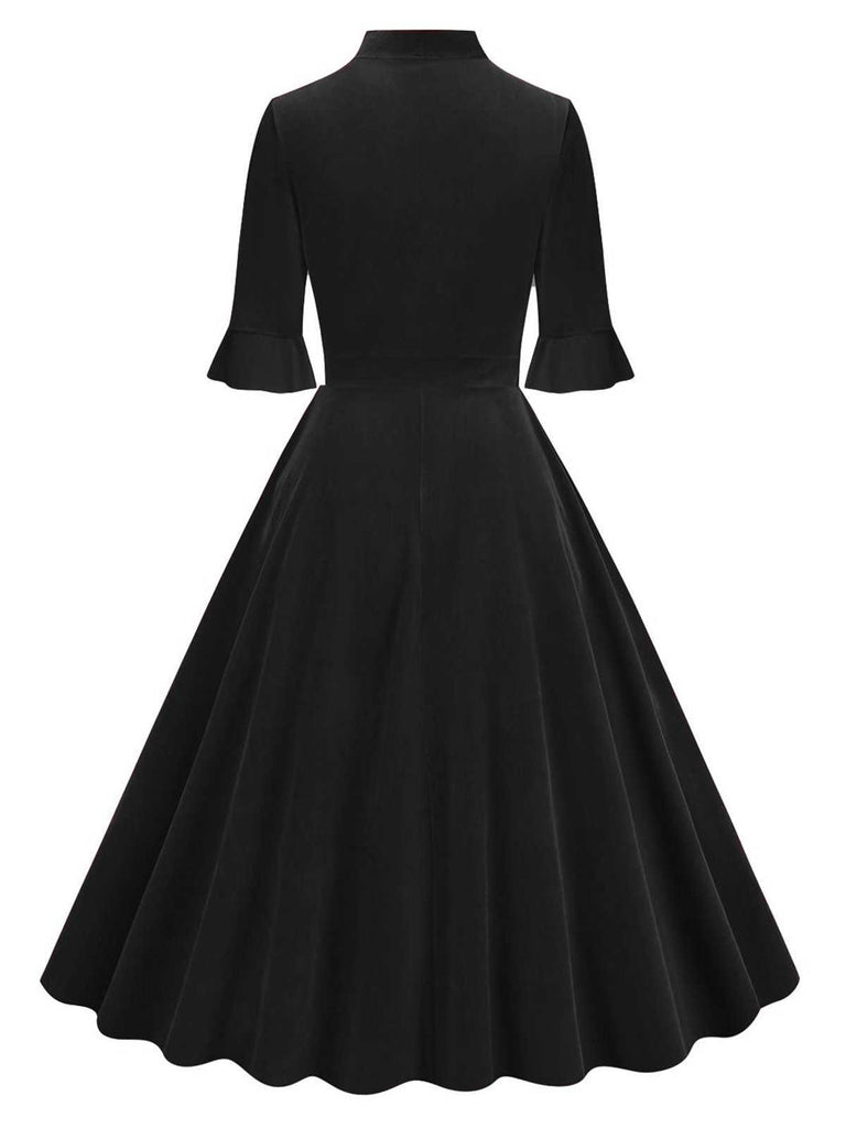 She slips into this 1950s Tie Neck Velvet Flared S