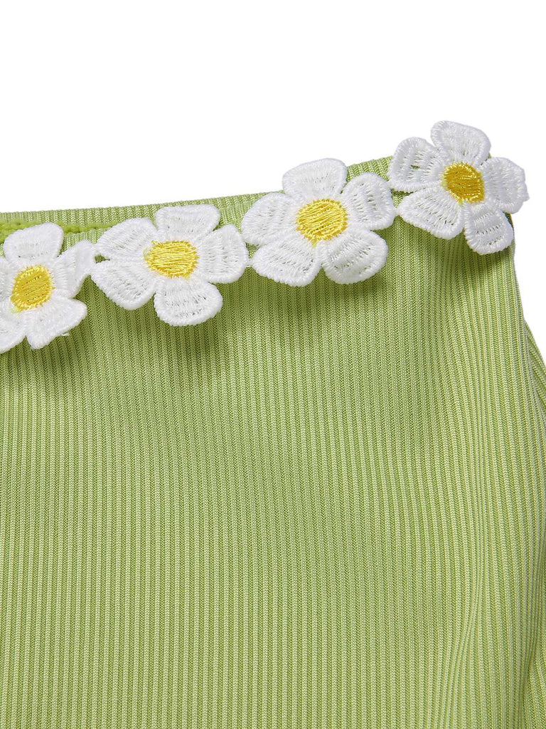 She's wearing 1960s Halter Knit Daisy Swimsuit and the whole beach remembers the 1960s