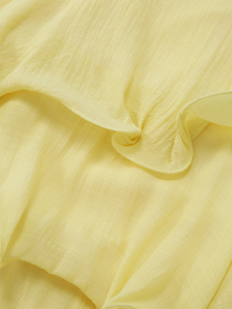 Close-up of light yellow fabric with ruffled edge