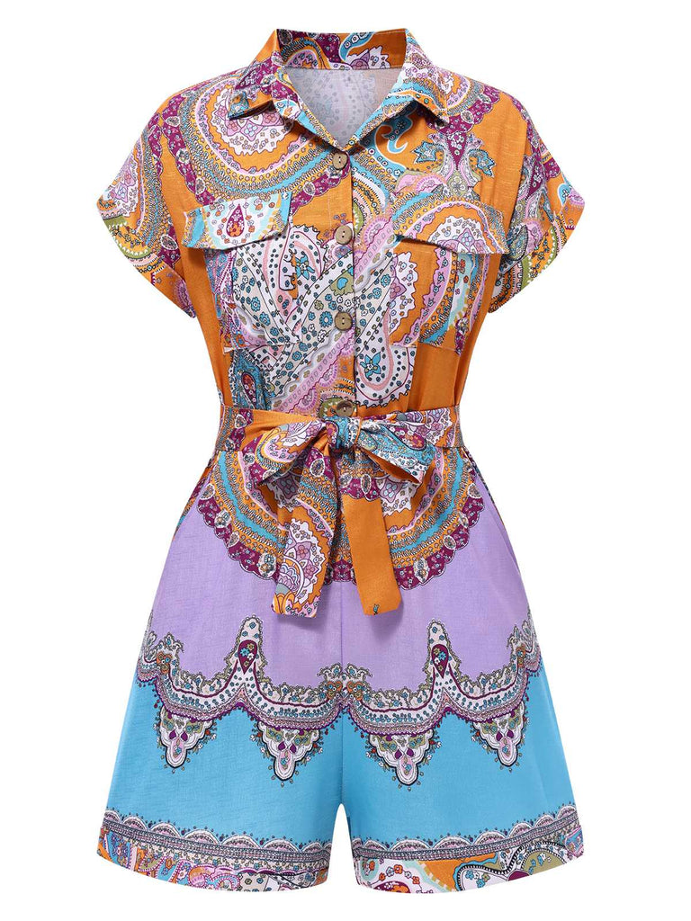 She pairs this 1970s Shirt Neck Paisley Print Belted Romper with confidence and 1970s charm