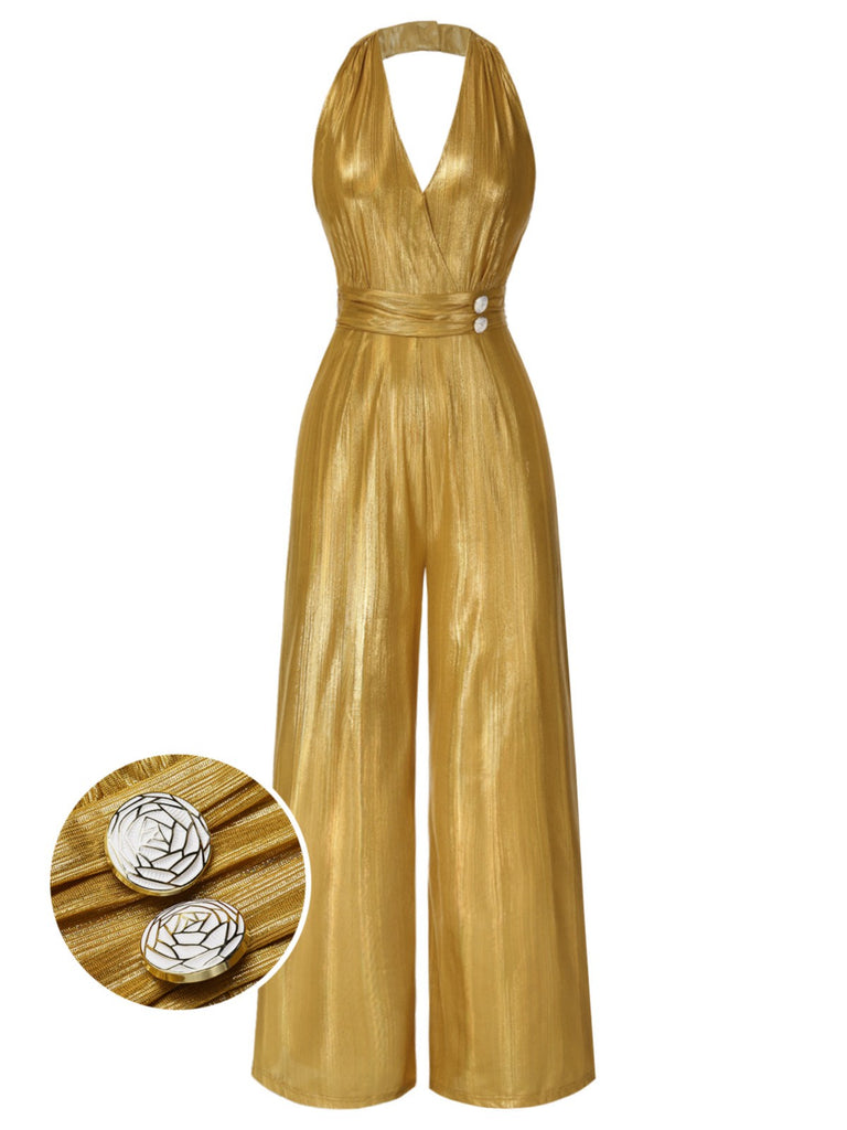 A shimmering gold 1970s style halter jumpsuit with a deep V-neck and wide-leg trousers, featuring ornate button details on the waist.