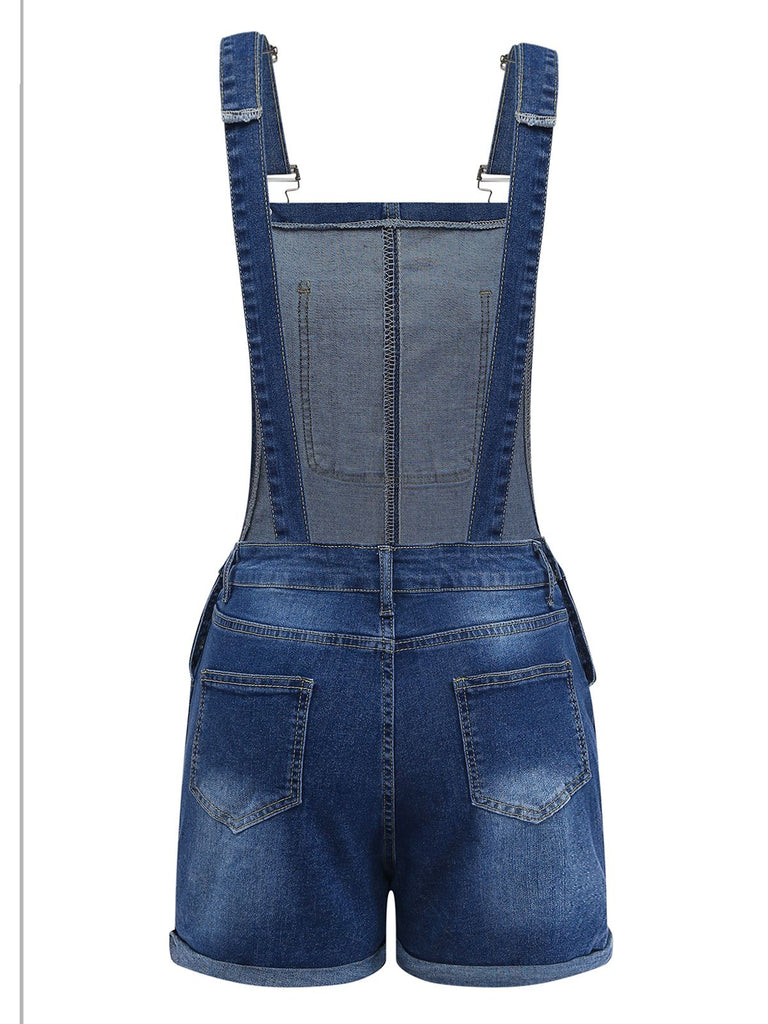 Blue denim overall shorts on a white background