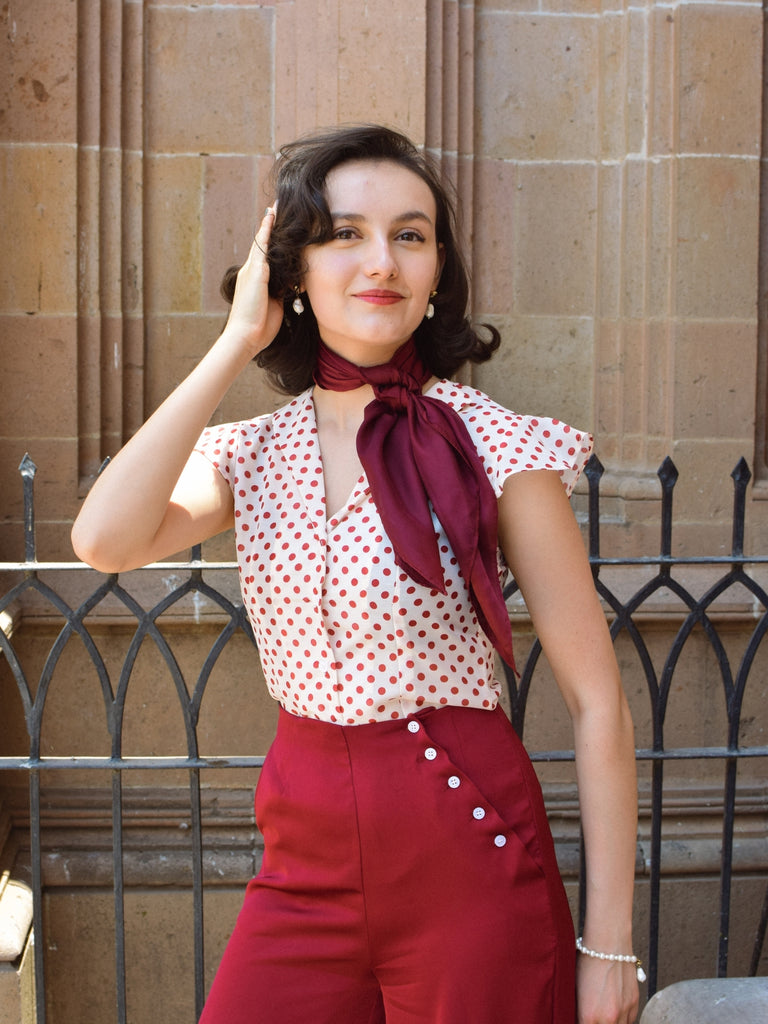 She pairs this 2PCS 1950s Red Polka Dot Blouse & Burgundy Pants with confidence and 1950s charm