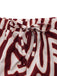 Red and white patterned shorts with a tie waist on a white background
