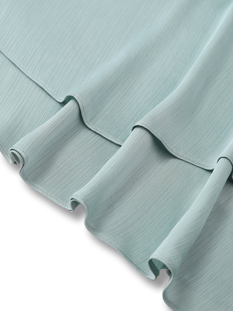 Close-up of a light blue textured fabric with pleated design