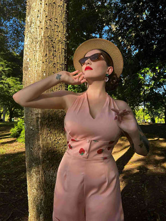 She sways in this 2PCS Pink 1950s Halter Strawberry Romper & Umbrella Skirt and it's pure 1950s magic