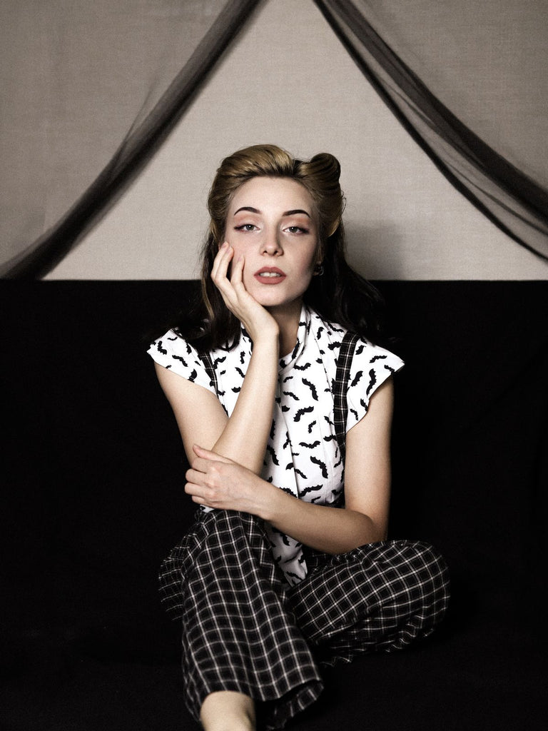 She pairs this 2PCS White Blouse Top & Suspender Pants with confidence and vintage charm