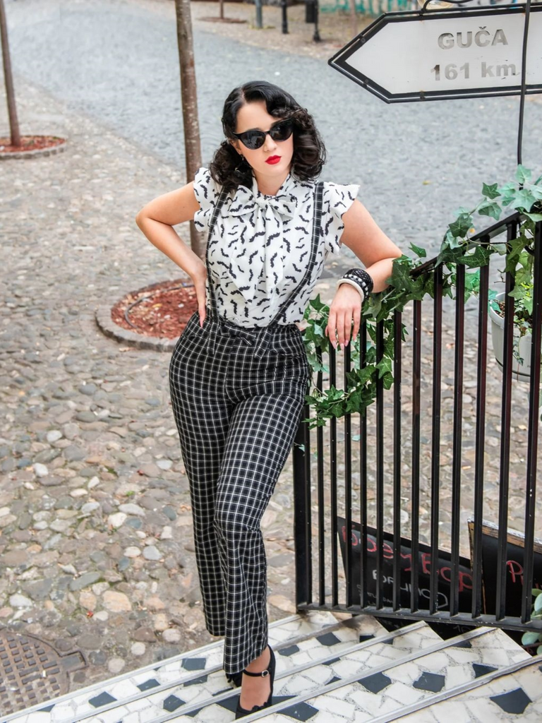 She pairs this 2PCS White Blouse Top & Suspender Pants with confidence and vintage charm