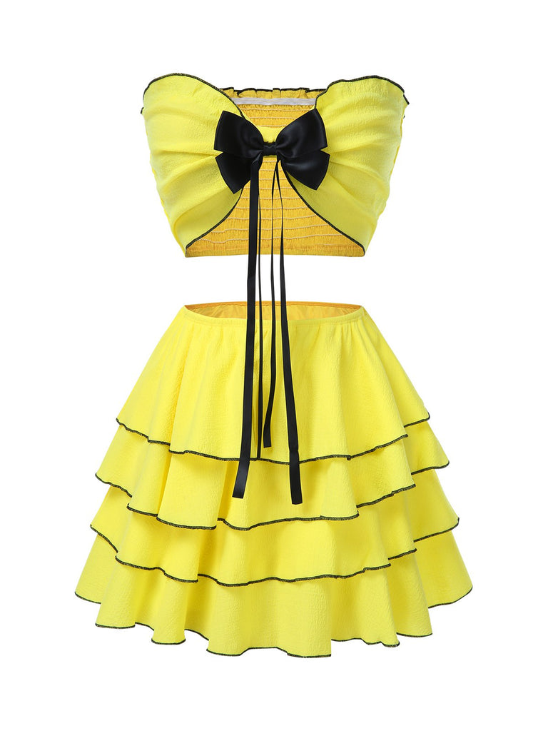 She pairs this 2PCS Yellow 1950s Bow Smocked Tube Top & Multi-Layer Skirt with confidence and 1950s charm