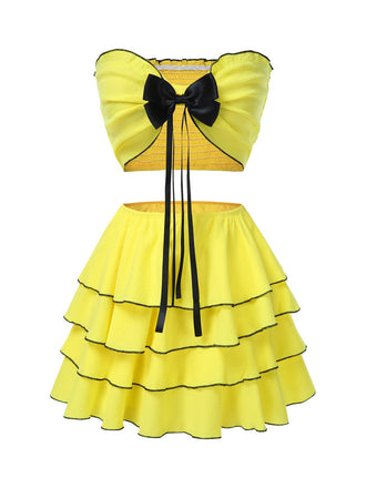 She pairs this 2PCS Yellow 1950s Bow Smocked Tube Top & Multi-Layer Skirt with confidence and 1950s charm