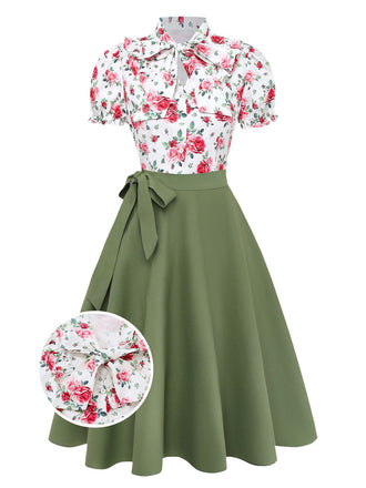 Vintage-style dress with floral top and green skirt on a white background