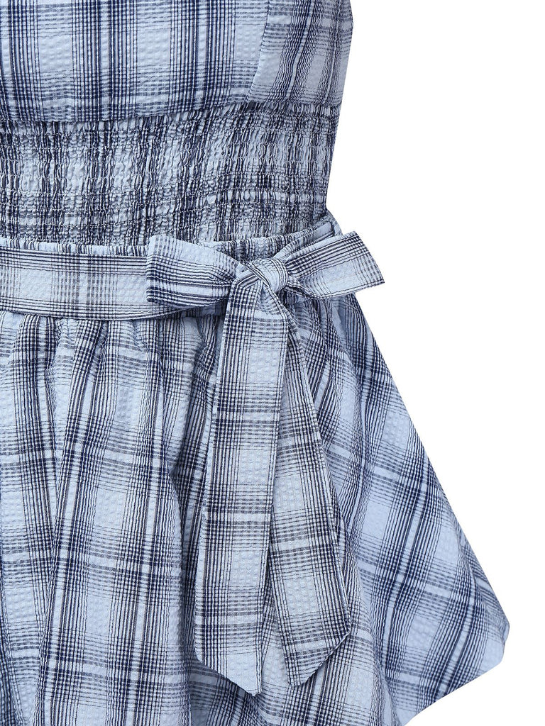 Close-up of a blue plaid dress with a tie waist on a white background