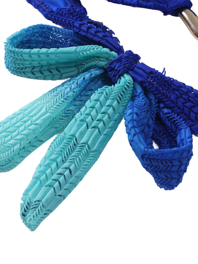 Close-up of blue and teal braided shoelaces on a white background