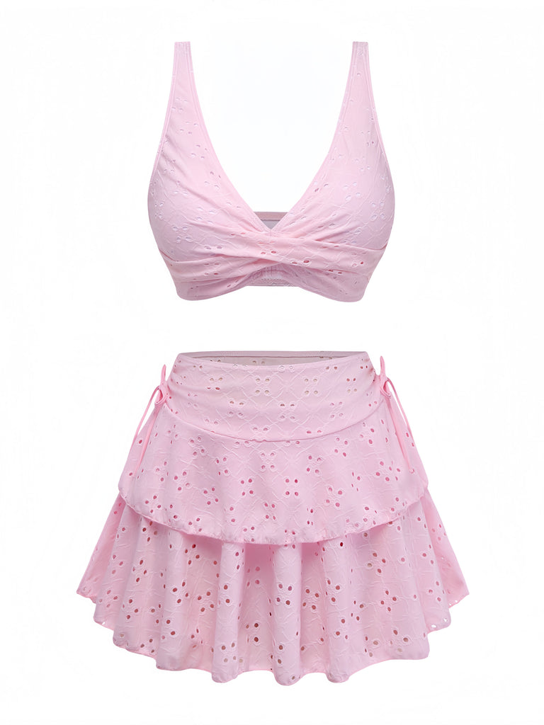 Pink two-piece swimsuit with a top and skirt on a white background