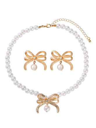 Pearl necklace with gold bow pendants on a white background