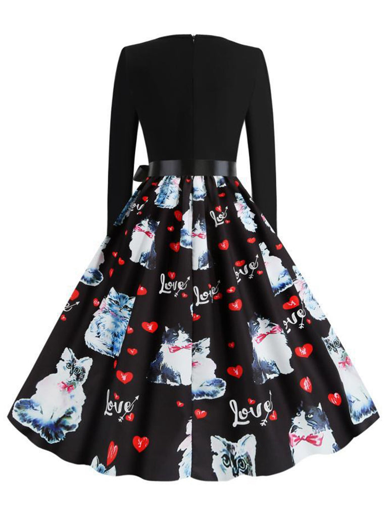 This Black 1950s Cat Heart Belted Dress wraps her in 1950s elegance, one twirl at a time