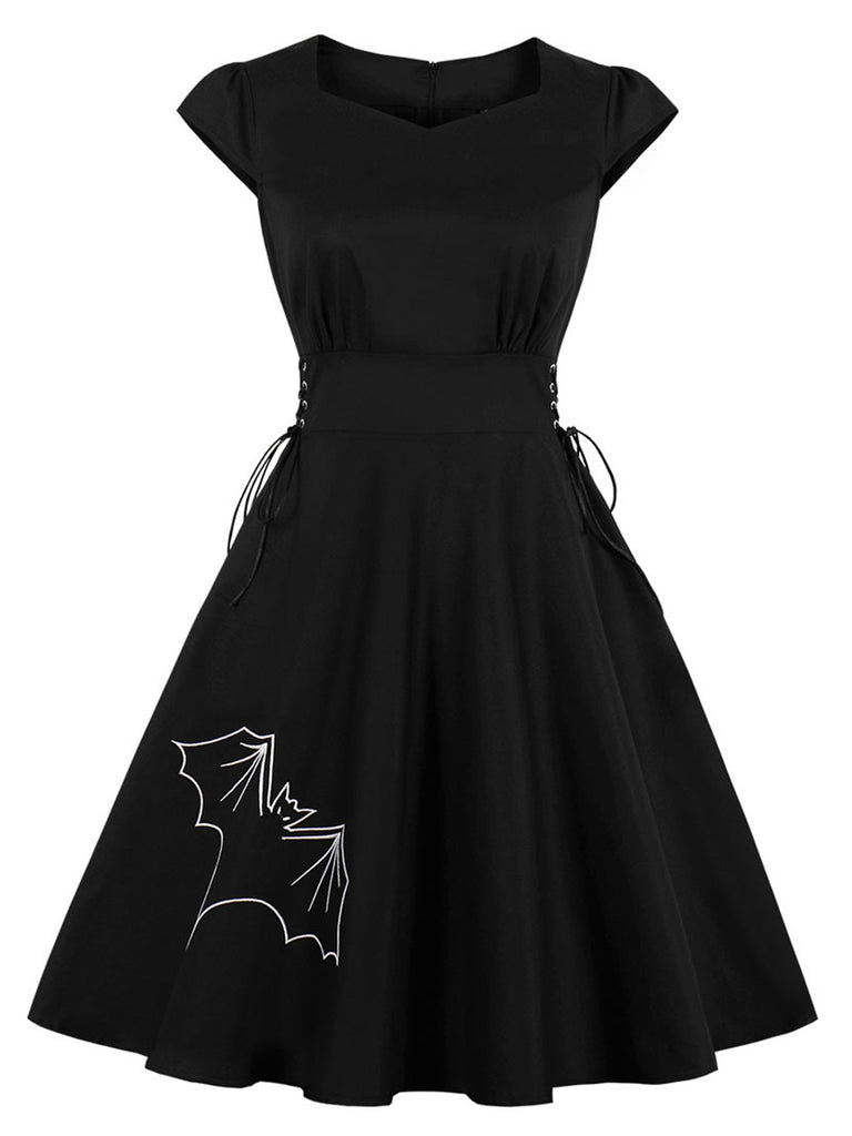 She slips into this Black 1950s Halloween Bat Lace-Up Dress and suddenly it's a 1950s daydream