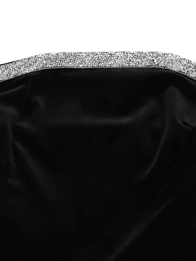 Black satin clutch with a silver embellished handle on a white background