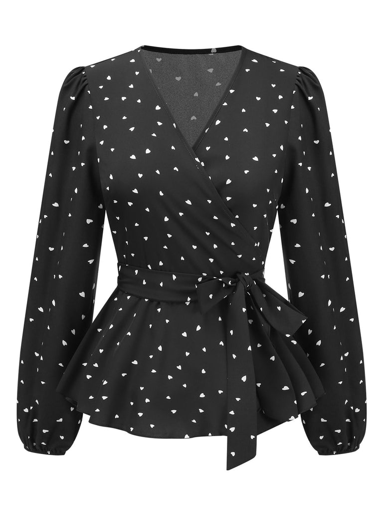 She pairs this Black 1960s Heart Dots V-Neck Belted Blouse with confidence and 1960s charm
