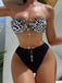 She's wearing Black 1970s Leopard Metal Button Strapless Swimsuit and the whole beach remembers the 1970s