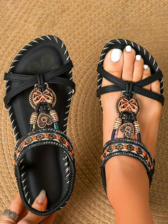 Bohemian flat sandals featuring beaded butterfly and heart rhinestone details, perfect for comfortable summer strolls or dressy beach resort wear.