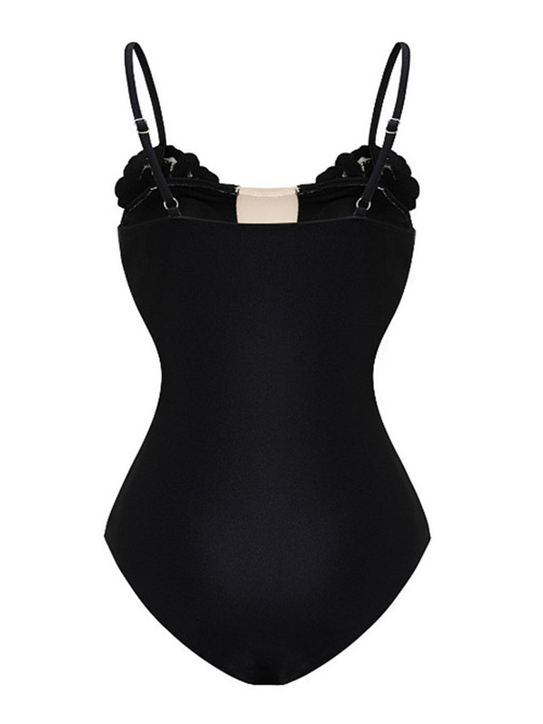 Black swimsuit with thin straps on a white background