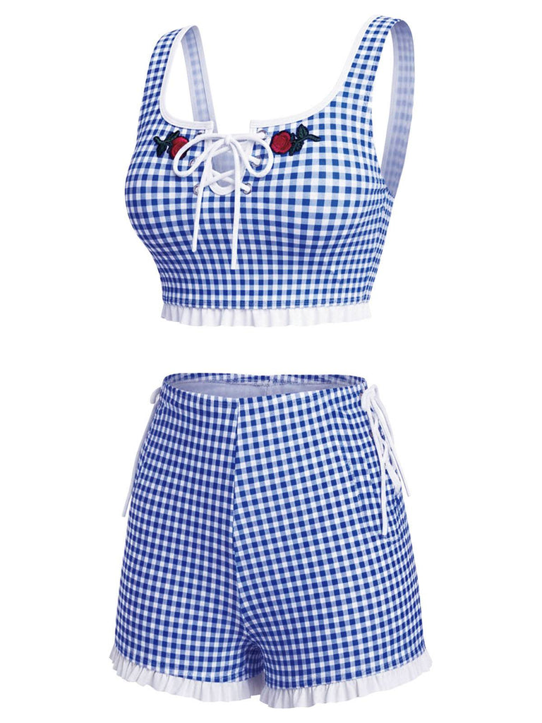 Blue and white checkered two-piece swimsuit with floral details on a white background