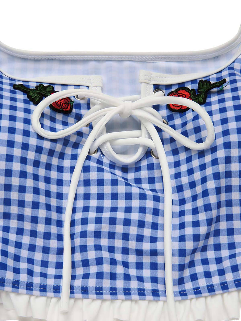 Blue and white checkered dress with white lace trim and embroidered roses.