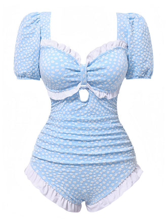 She's wearing Blue 1940s Ditsy Floral Ruffles One-Piece Swimsuit and the whole beach remembers the 1940s