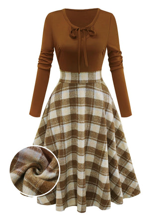 She slips into this Brown 1950s Tie-Neck Knit Plaid Dress and suddenly it's a 1950s daydream